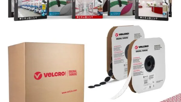 VELCRO® Brand fastening solutions including high-strength fasteners, ONE-WRAP® tape, general-purpose fasteners and ultra-thin fasteners shown in rolls and retail packaging with a VELCRO® Brand shipping box in the background.